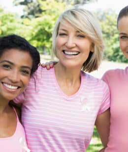 Three women wearing pink