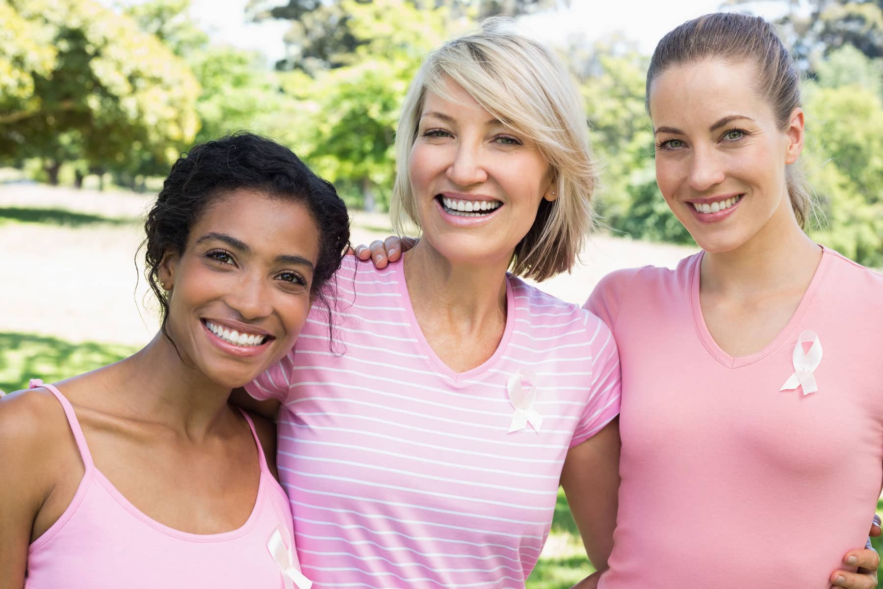 Three women wearing pink